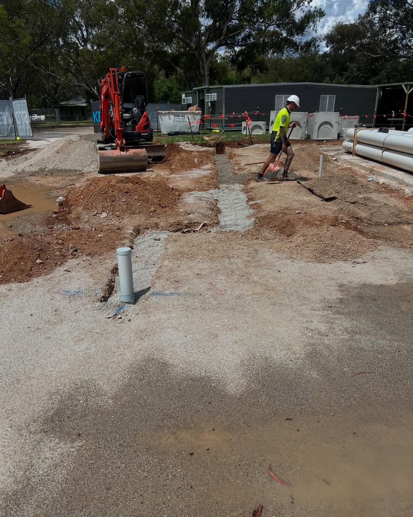 Civil site with excavator and crew